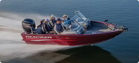 Red speedboat racing across calm, vibrant blue water with four passengers on board, leaving a white trail of waves behind