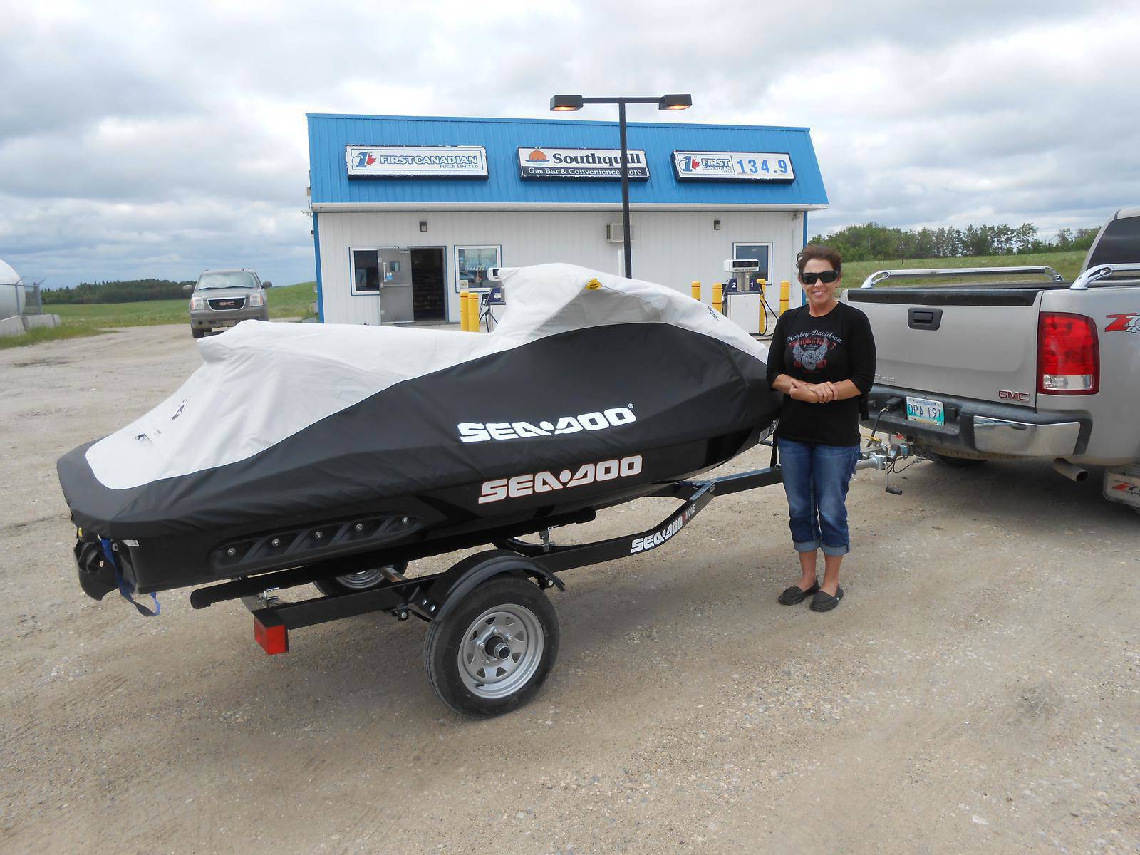Woman standing beside a Sea-Doo watercraft.