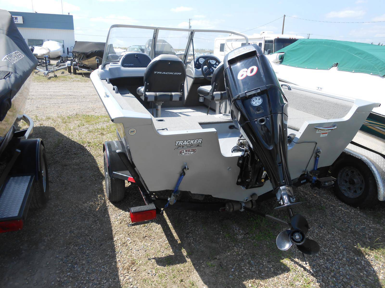 Rear view of a gray Tracker fishing boat with a 60 horsepower outboard motor.